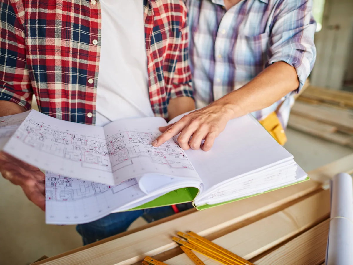 Sanchez Construction team reviewing project plans with a homeowner